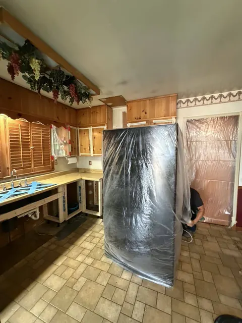 Appliances and openings wrapped in protective sheeting
