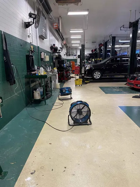 Axial fans drying the floor of a commercial automotive shop