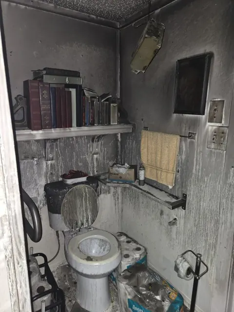 Smoke and fire affected bathroom documented for cleaning and deodorization
